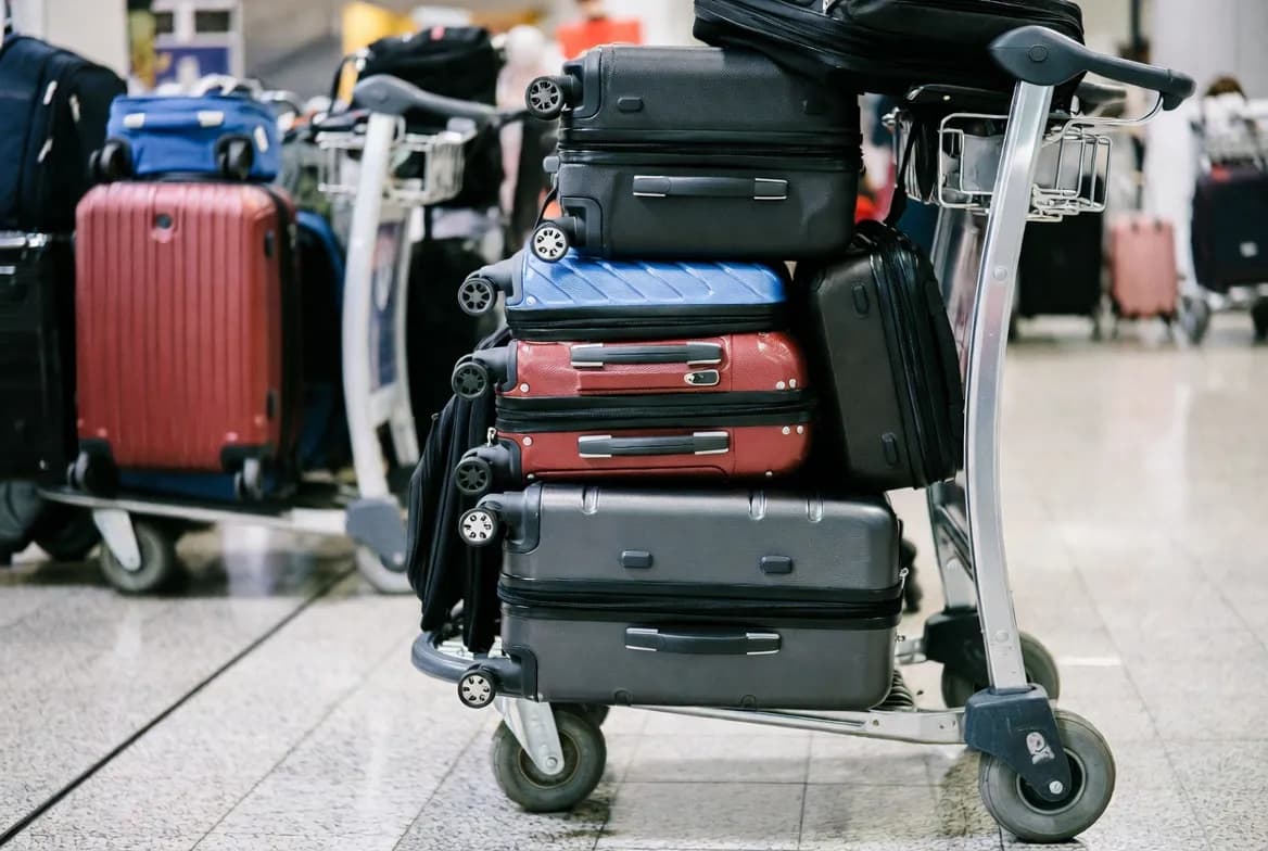 Top 10 largest carry on luggage options stacked on a luggage cart